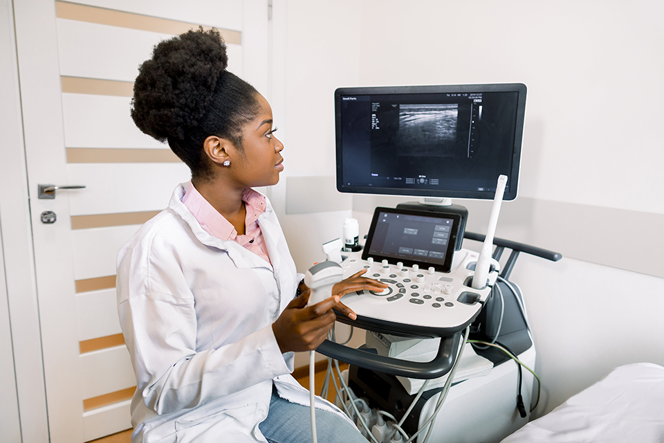 A woman conducting an endovaginal ultrasound.