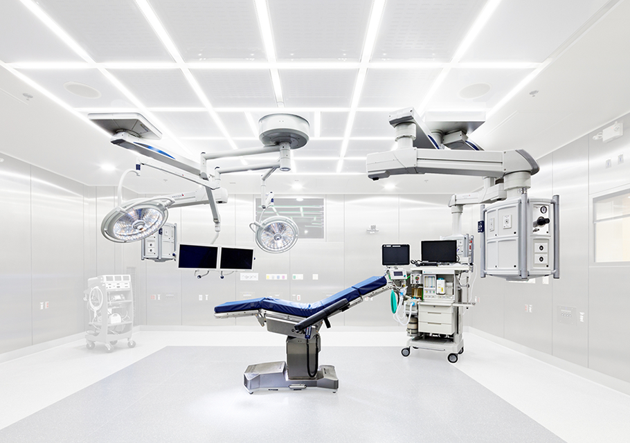 An operating room with a table and medical device accessories. 