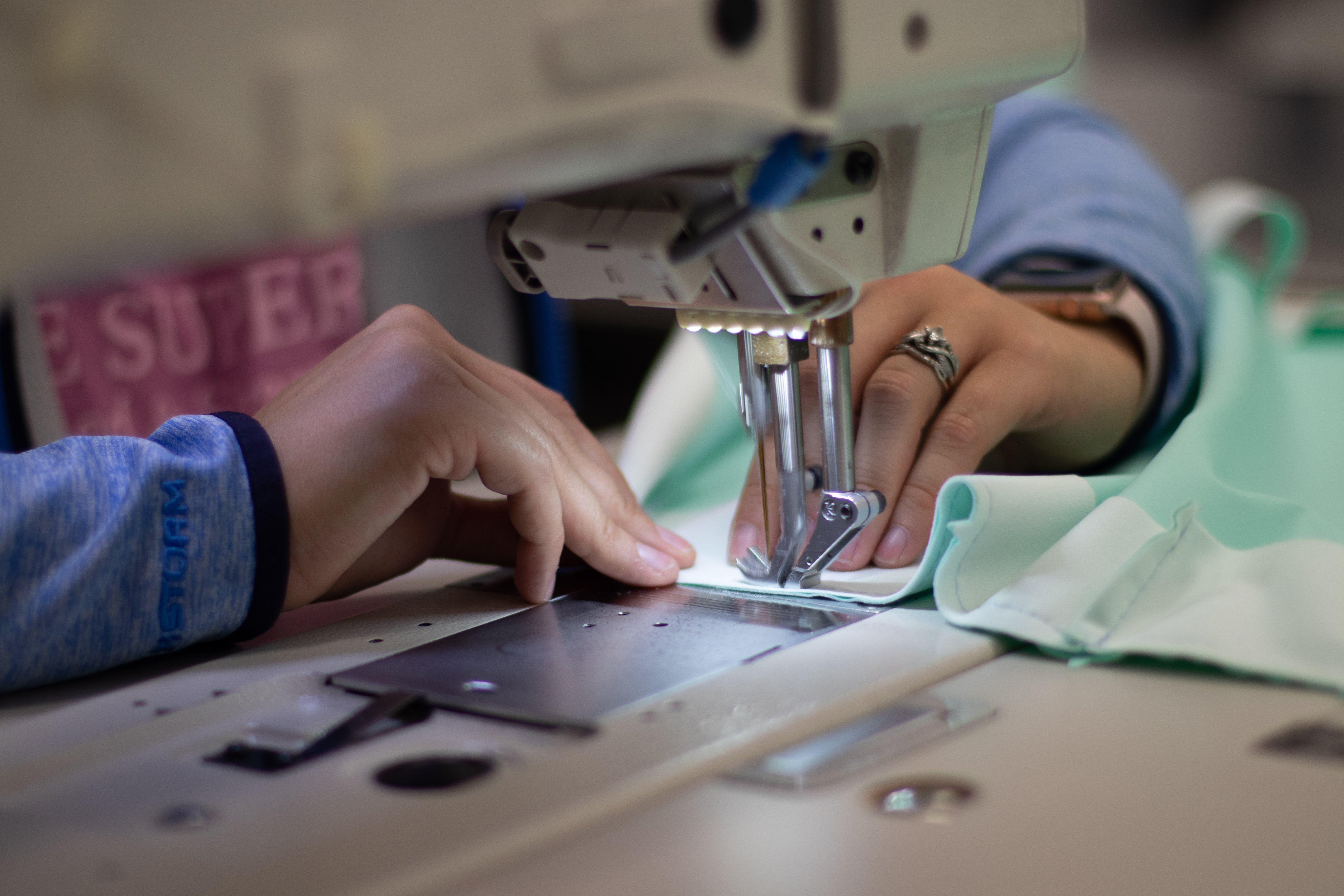 A lady sewing a medical device