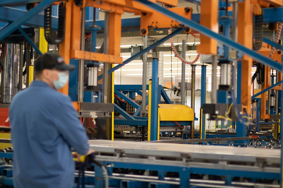 A man operating a compression molding machine. 