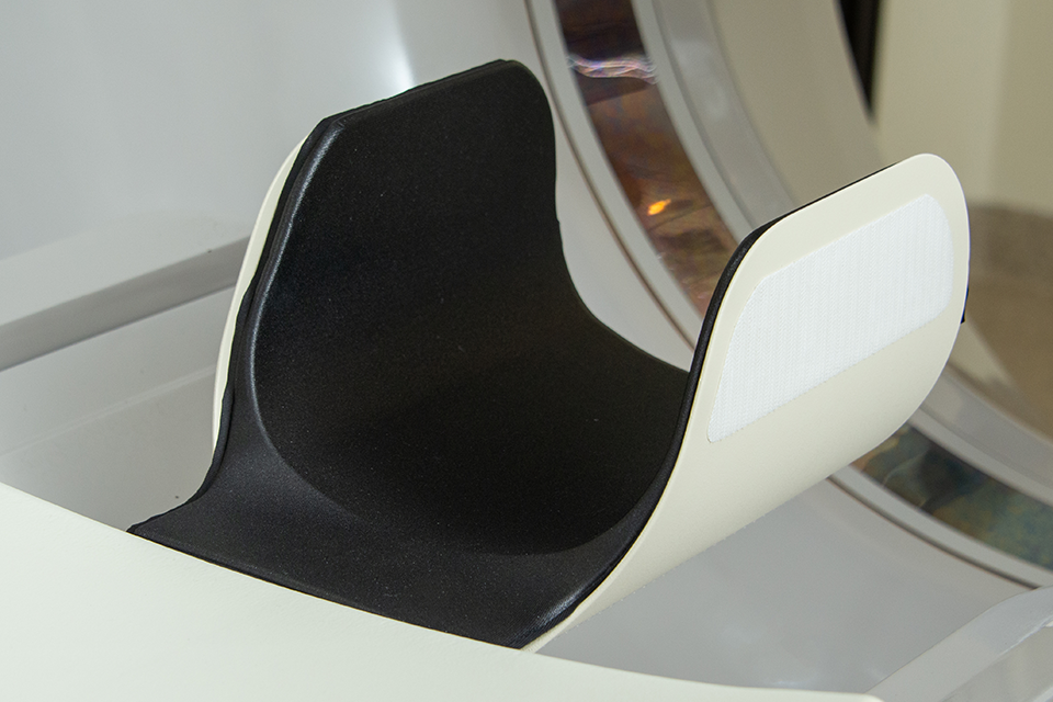 A photo of the Domico Med-Device Canon Carbon Fiber Head Holder with a foam pad inserted into it.