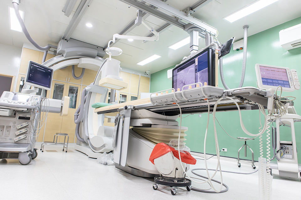 A photo of an angiography table taken from a low angle.