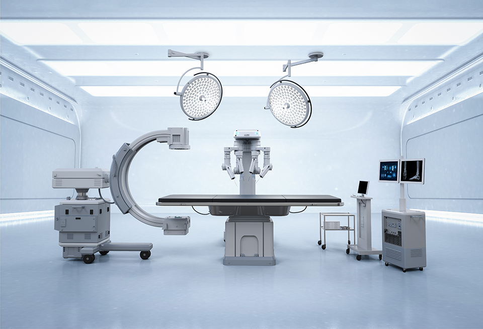 A photo of an operating room with a surgical robot.