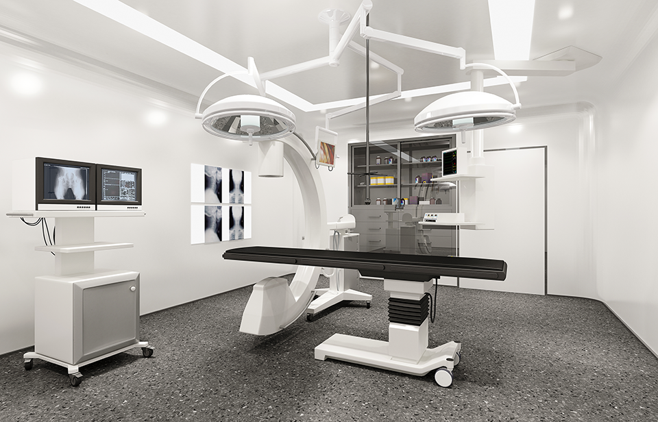 Image of an operating with a table in the center and a C-Arm attached to the table.