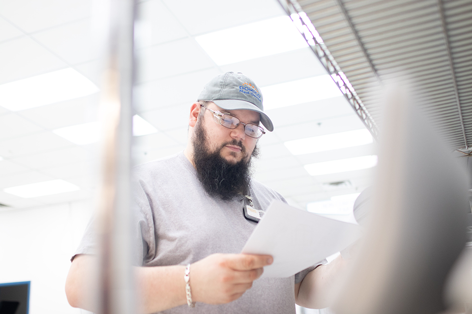 A man conducting quality control review for a medical device manufacture for OEMs