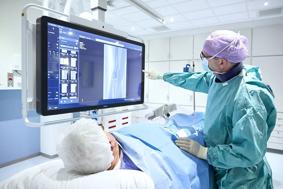 A doctor reviewing x-ray results in an Image Guided Therapy Operating Room 