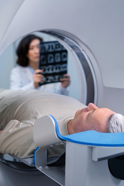 A man getting a CT scan done in radiology department in the hospital 