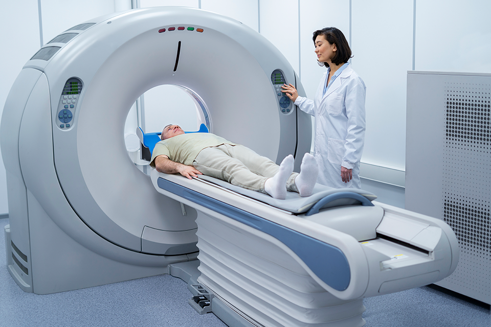 Doctor getting a patient ready for an MRI scan 