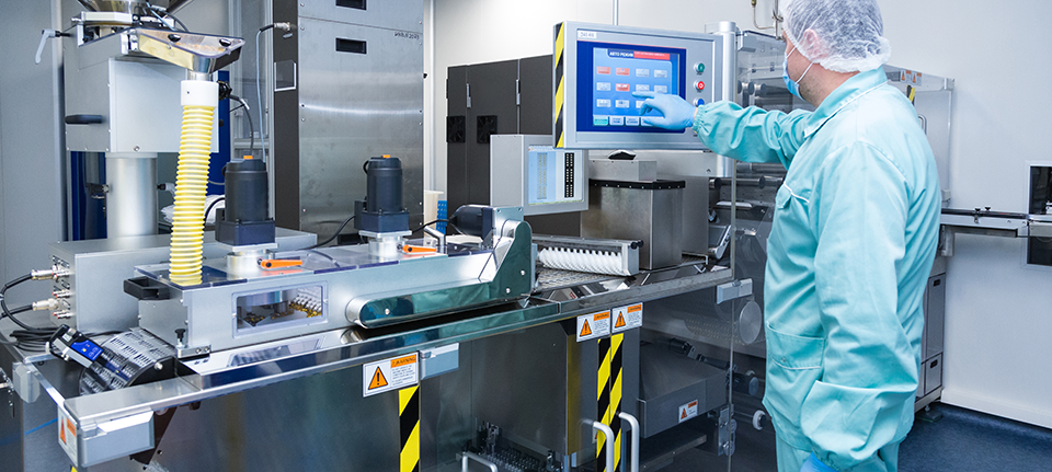 medical device industry factory man worker protective clothing sterile working conditions operating equipment